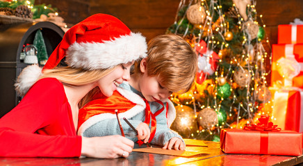 Obraz na płótnie Canvas Mom and kid play together christmas eve. Happy family. Family holiday. Mother and little child boy adorable friendly family having fun. Joy and happiness. Family having fun at home christmas tree