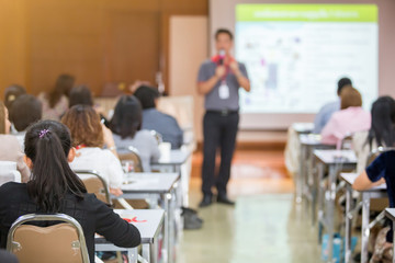 selective focus to business woman with blurry man speaker for meeting or seminar event in the meeting room. They are brain business solving problem
