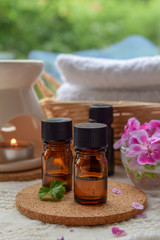 Obraz na płótnie Canvas essential oils with rose geranium flower at spa salon