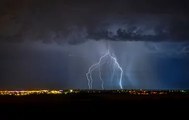 Fotobehang lightning over the city © Павел Кочубеев