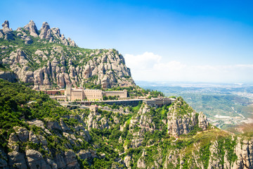 Montserrat Monastery is located on the mountain of Montserrat, Catalonia, Barcelona, Spain Sunny day, blue sky - obrazy, fototapety, plakaty