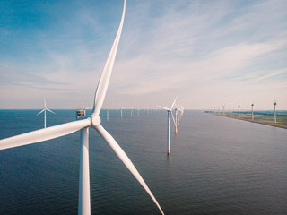 Fototapeta windmill farm renewable enrgy, green energy with windmill park in ocean and land obraz