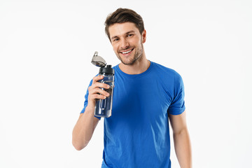 Fototapeta na wymiar Photo closeup of handsome man in casual t-shirt smiling and holding water bottle