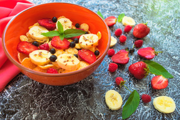 A plate of muesli with berries, banana and flax seeds is decorated with mint leaves. Healthy and healthy breakfast. Top view