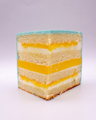 Piece of cake. Sponge cake with mango. On a white background.