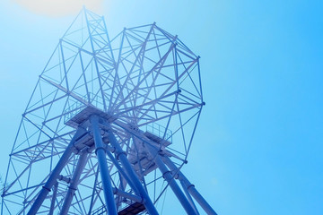 Set up of ferris wheel in amusement park at sky background.