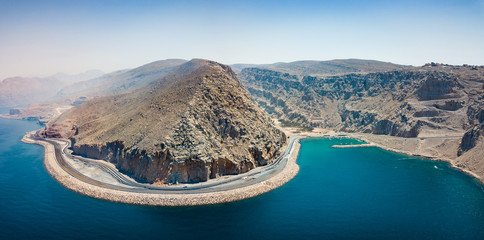 Coastal highway and fjords of Musandam in Oman aerial view - obrazy, fototapety, plakaty