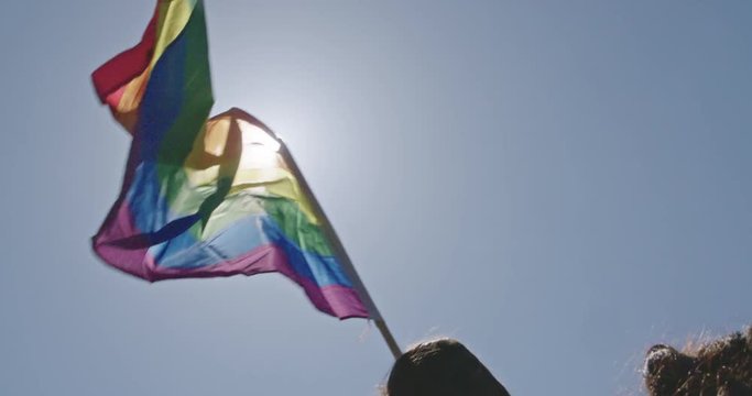 Pride LGBT rainbow flag waving in slow motion during a pride parade