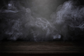 blank wood table with dark interior backgroundwith mist or fog and smoke backdrop to present...