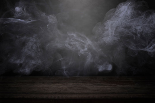 blank wood table with dark interior backgroundwith mist or fog and smoke backdrop to present products