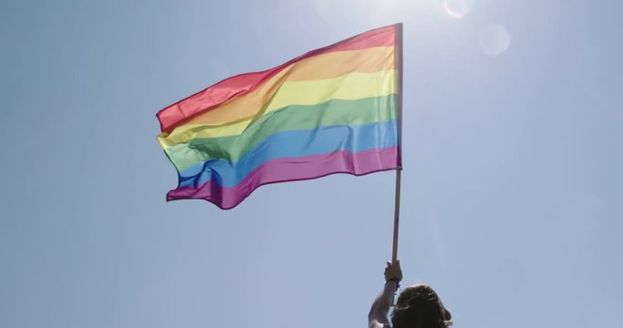 Pride LGBT rainbow flag waving in slow motion during a pride parade