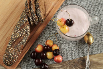 cherry yogurt fresh sweet cherries and baguette on table