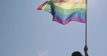 Pride LGBT rainbow flag waving in slow motion during a pride parade