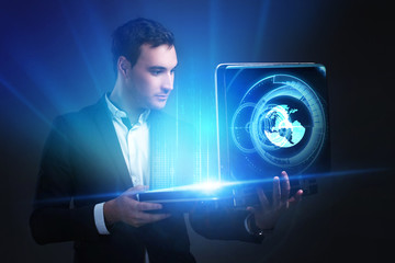 The concept of business, technology, the Internet and the network. A young entrepreneur working on...