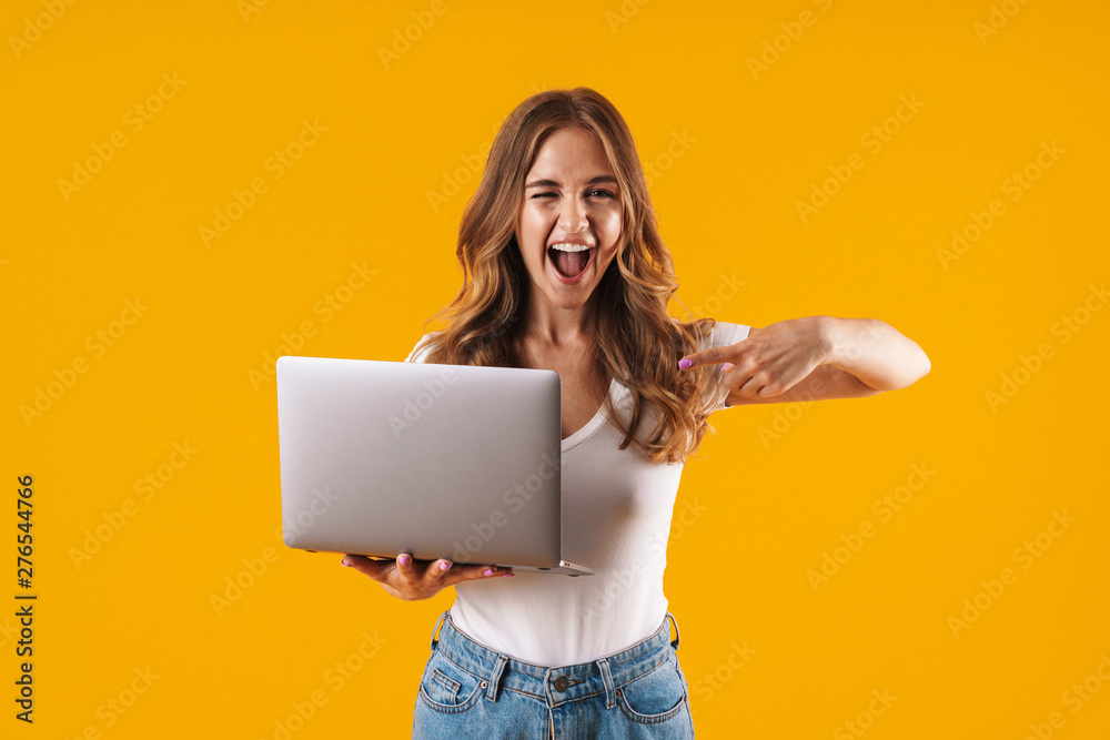 Wall mural Portrait of a cheerful young casual girl standing