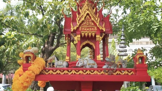 Spirit House in Thailand San Phra Phum with protective spirits of a place or house of the guardian spirit green trees background