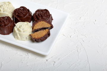Homemade sweets. Chocolate coated sweets with almond filling. Cake pops decorated with a bow of braid. 