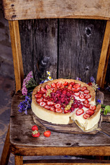 tart with fresh strawberries, raspberries and currants in a rustic style