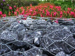 Close-up Fence Made of Stones Under Metal Wire Mesh with Selective Focus