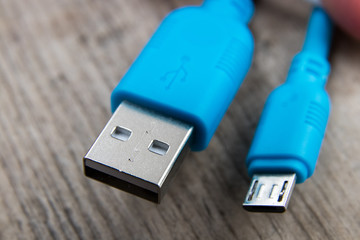 blue usb cable on a wooden board