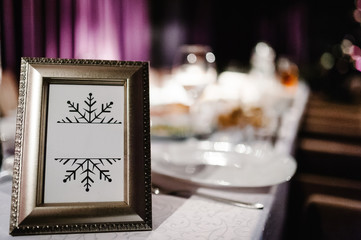 Mock up. Menu frame on table in restaurant. Blank blackboard. Stand for booklets with white sheets of paper, tent, card on cafeteria, blurred. Close up. Place for text.