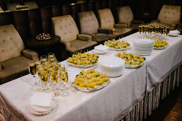 Festive table with champagne and snacks. close up.