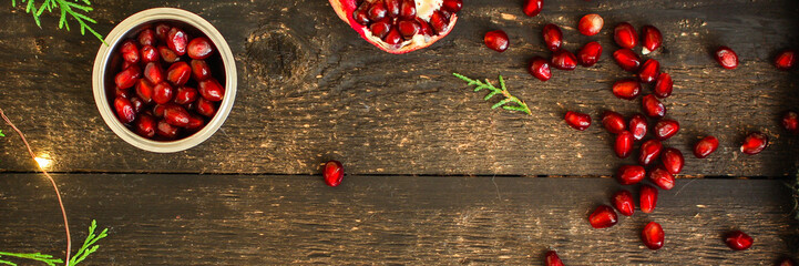 pomegranate fruit red and branches green  (vitamin dessert) festive atmosphere. top food background. copy space