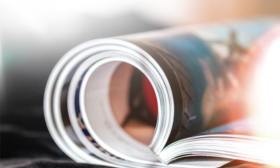 Rolled up magazines with reflection on  background