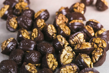 Beautiful tasty chocolates handmade candies with walnuts on bakers paper