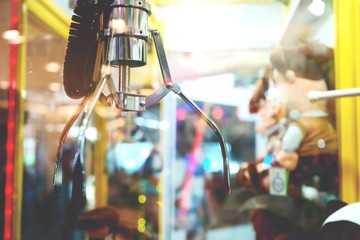 Machine claw grabber game in a vending machine close up