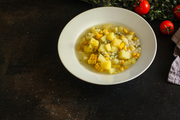 soup with corn and vegetables (cob, first course). top food background. copy space