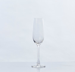 Empty Champagne Glass and Reflection on White