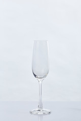 Empty Champagne Glass and Reflection on White
