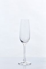 Empty Champagne Glass and Reflection on White