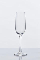 Empty Champagne Glass and Reflection on White