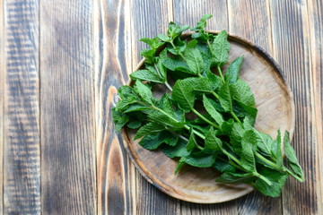 Fresh mint leaves on wooden background Top view