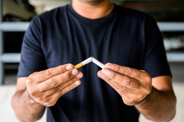 Male hand crushing cigarette. Stop smoking concept