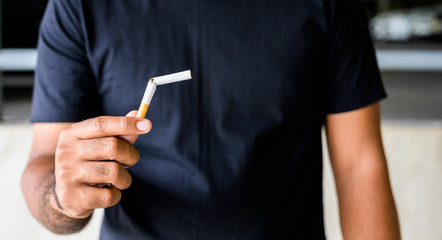 Male hand crushing cigarette. Stop smoking concept