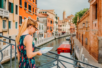 Fototapeta na wymiar Young woman holding a map in Venice, Italy