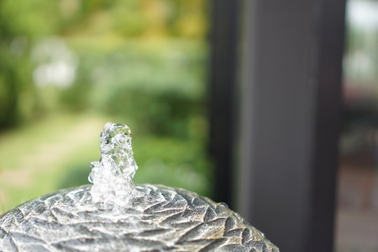 A Small Fountain With A Garden Decoration. 