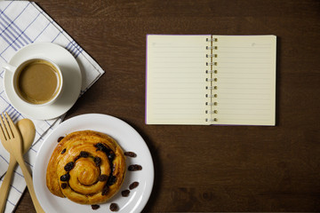 Flat lay of custard raisin danish and coffee
