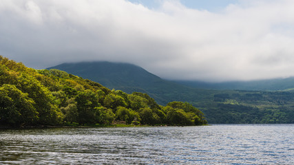 Stormy clouds gathering over the lake and mountains. Landscape in Killarney, County Kerry, Ireland. Typical Irish summer weather.