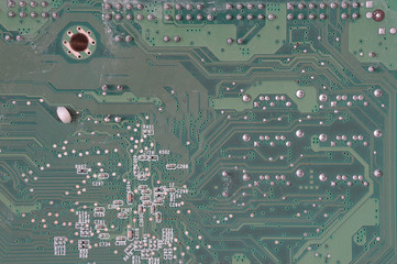 Old and dusty computer motherboard with resistors and connectors