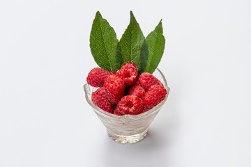 Raspberries in a plate. Isolated