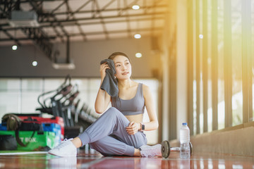 Sporty woman with towel in gym after training	