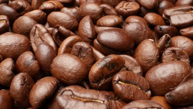 Close-up, smooth moving roasted coffee beans