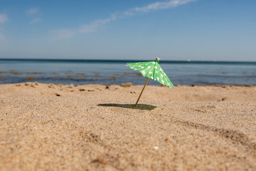 Fototapeta na wymiar cocktail umbrella on the beach - Schleswig Holstein Germany