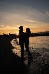 silhouette of couple at sunset beach