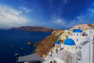 Fototapeta premium Blue and white colours of Oia City. Magnificent panorama of the island of Santorini Greece during a beautiful sunrise in the Mediterranean. Love and travel background
