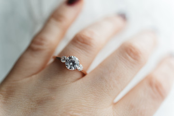 Close up of a womans hand wearing an engagement ring